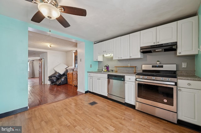 2619 E Dauphin St, Philadelphia, PA 19125 - kitchen featuring appliances with stainless steel finishes, under cabinet range hood, light wood finished floors, white cabinets, and a ceiling fan