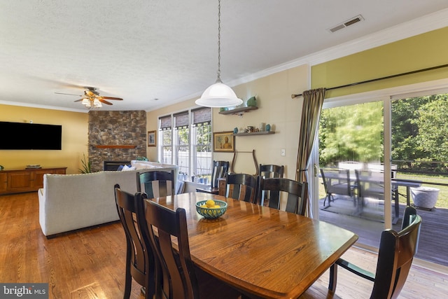 1207 Painted Fern Rd, Denton, MD 21629 - dining room with ornamental molding, ceiling fan, wood finished floors, and a fireplace