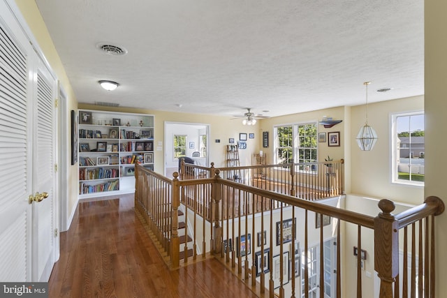 1207 Painted Fern Rd, Denton, MD 21629 - hall with an upstairs landing, wood finished floors, and a textured ceiling