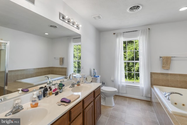 1207 Painted Fern Rd, Denton, MD 21629 - full bathroom featuring double vanity, healthy amount of natural light, a tub with jets, and recessed lighting