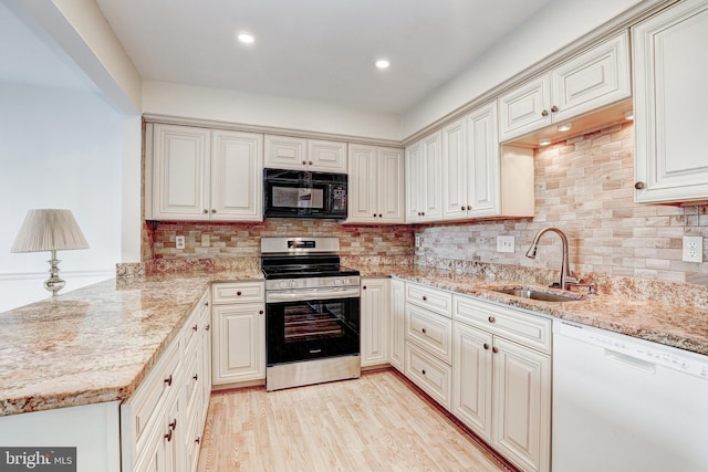 1 Smeton Place 506 & 606, Towson, MD 21204 - kitchen featuring black microwave, white dishwasher, stainless steel electric range oven, a sink, and light stone counters