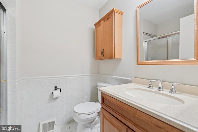 3447 Norwood Pl, Southampton, PA 18966 - bathroom with vanity, a stall shower, a wainscoted wall, tile walls, and tile patterned floors
