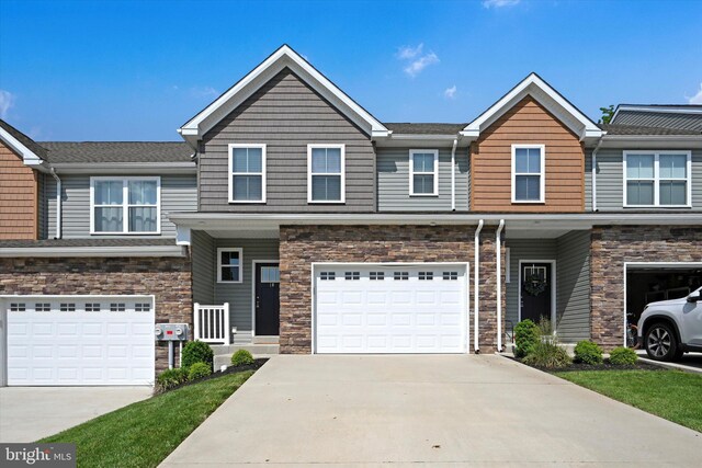 10 Hubbardton Ct, Sinking Spring, PA 19608 - view of property with concrete driveway, a garage, and stone siding