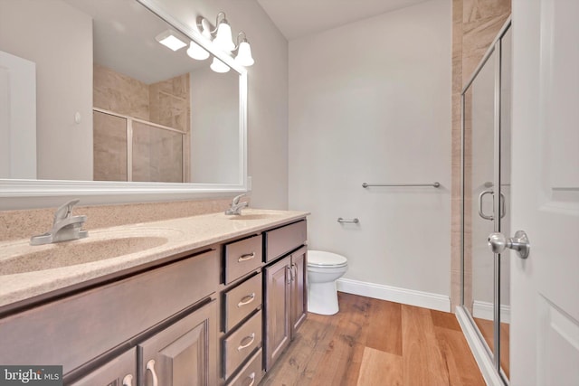 10 Hubbardton Ct, Sinking Spring, PA 19608 - bathroom featuring double vanity, a shower stall, wood finished floors, toilet, and baseboards