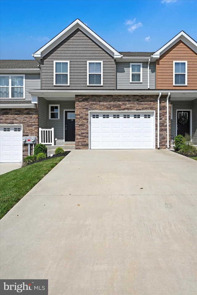 10 Hubbardton Ct, Sinking Spring, PA 19608 - view of property featuring a porch, stone siding, driveway, and an attached garage