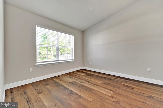 10 Hubbardton Ct, Sinking Spring, PA 19608 - spare room with vaulted ceiling, wood finished floors, and baseboards