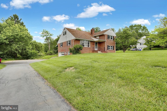 1415 Rockland St, Reading, PA 19604 - tri-level home featuring brick siding, a chimney, a garage, driveway, and a front yard