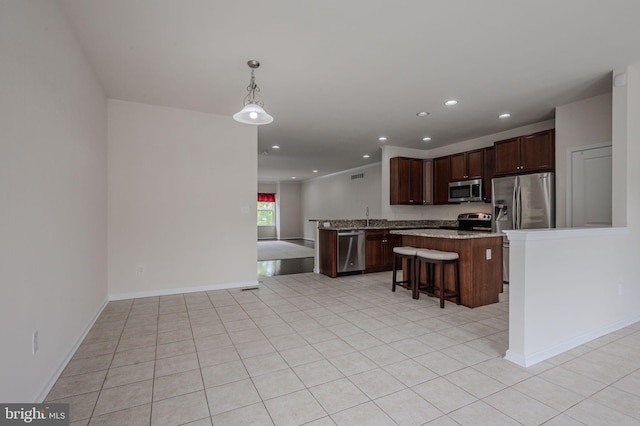 309 Latrobe Dr, Newark, DE 19702 - kitchen with appliances with stainless steel finishes, a kitchen bar, recessed lighting, open floor plan, and a center island
