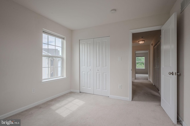 309 Latrobe Dr, Newark, DE 19702 - unfurnished bedroom featuring light colored carpet, baseboards, and a closet