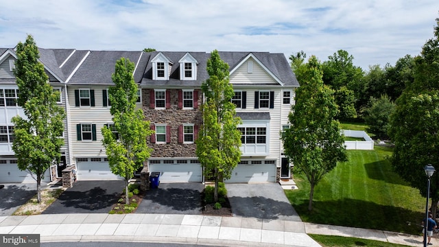 309 Latrobe Dr, Newark, DE 19702 - view of property featuring stone siding, a garage, driveway, and a front lawn