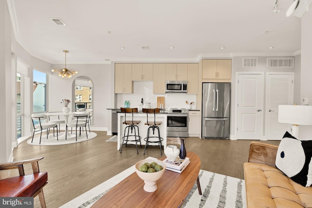 2550 17th St NW Unit 414, Washington, DC 20009 - living room with wood finished floors, ornamental molding, arched walkways, recessed lighting, and baseboards