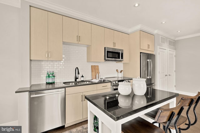 2550 17th St NW Unit 414, Washington, DC 20009 - kitchen with appliances with stainless steel finishes, a sink, baseboards, a kitchen bar, and decorative backsplash
