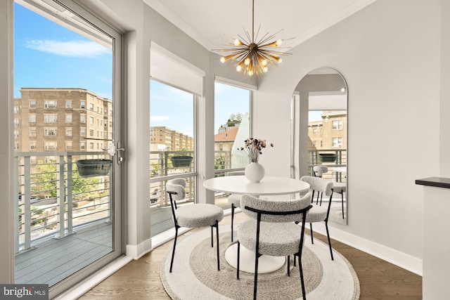 2550 17th St NW Unit 414, Washington, DC 20009 - dining room with baseboards, a chandelier, crown molding, arched walkways, and wood finished floors