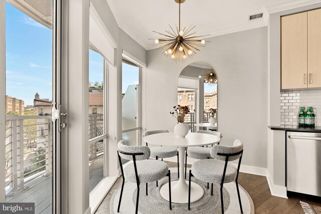 2550 17th St NW Unit 414, Washington, DC 20009 - dining space featuring crown molding, a chandelier, plenty of natural light, dark wood-style flooring, and baseboards