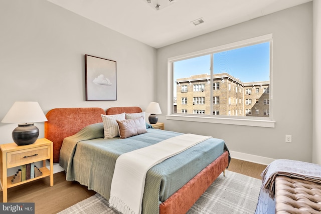 2550 17th St NW Unit 414, Washington, DC 20009 - bedroom with wood finished floors and baseboards