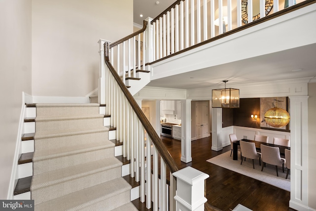 12220 Worthington Rd, Owings Mills, MD 21117 - staircase with a chandelier, wood finished floors, a high ceiling, and crown molding