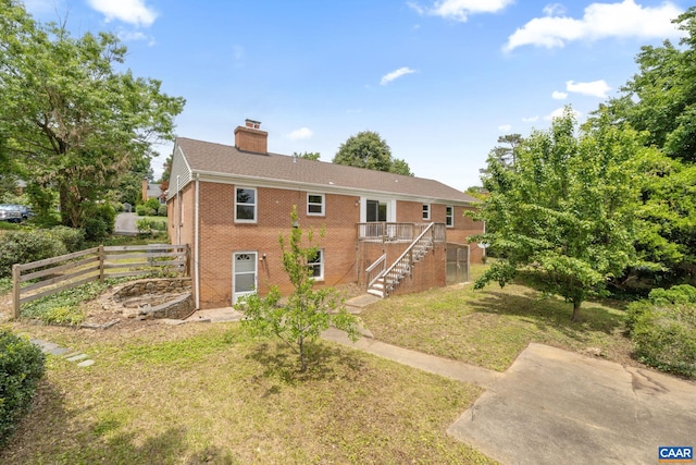 104 Chaucer Rd, Charlottesville, VA 22901 - view of front of home with a chimney, brick siding, stairway, and a deck