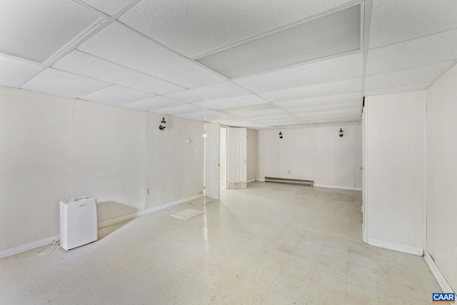 104 Chaucer Rd, Charlottesville, VA 22901 - finished basement featuring tile patterned floors, a paneled ceiling, a baseboard heating unit, and baseboards