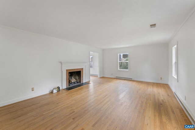 104 Chaucer Rd, Charlottesville, VA 22901 - unfurnished living room with a baseboard heating unit, a fireplace, ornamental molding, light wood finished floors, and baseboards