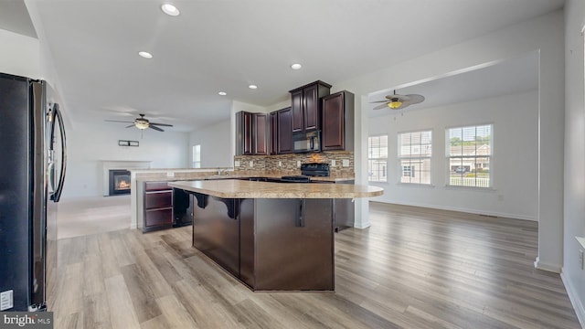 637 Coldwater Dr, Clayton, DE 19938 - kitchen featuring black appliances, ceiling fan, light countertops, open floor plan, and recessed lighting