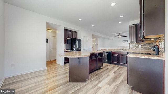 637 Coldwater Dr, Clayton, DE 19938 - kitchen featuring black appliances, light countertops, light wood-type flooring, tasteful backsplash, and recessed lighting