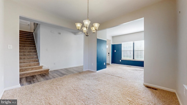 637 Coldwater Dr, Clayton, DE 19938 - spare room with carpet, stairs, a chandelier, and baseboards