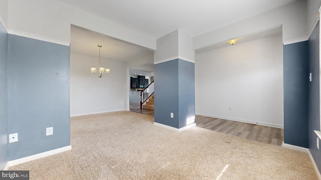 637 Coldwater Dr, Clayton, DE 19938 - carpeted empty room featuring a chandelier, stairs, and baseboards