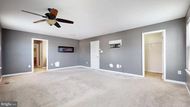 637 Coldwater Dr, Clayton, DE 19938 - unfurnished bedroom with a walk in closet, baseboards, carpet floors, and a ceiling fan