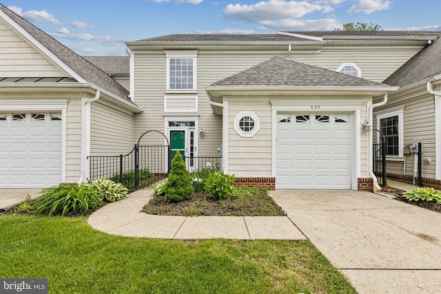 633 Ruxton Rd Unit 75, Solomons, MD 20688 - traditional home featuring concrete driveway, a garage, and a shingled roof