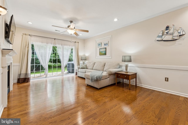 633 Ruxton Rd Unit 75, Solomons, MD 20688 - living room with a ceiling fan, wood finished floors, a fireplace, recessed lighting, and ornamental molding