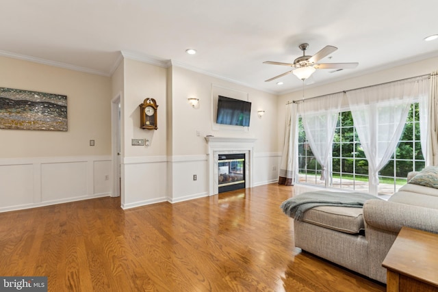 633 Ruxton Rd Unit 75, Solomons, MD 20688 - living room featuring ornamental molding, a ceiling fan, wood finished floors, a glass covered fireplace, and recessed lighting