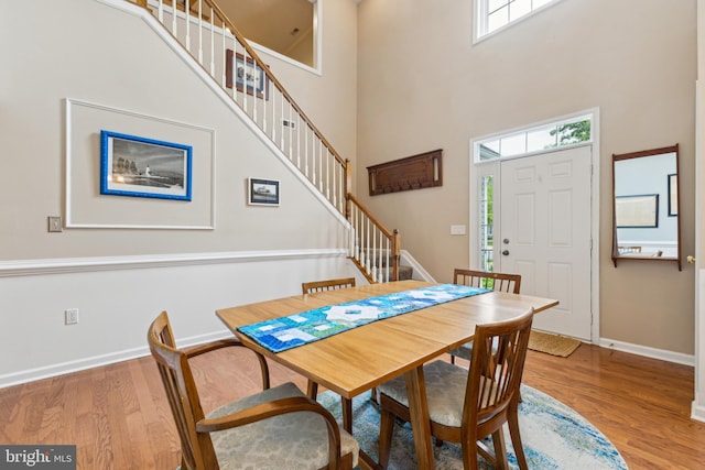 633 Ruxton Rd Unit 75, Solomons, MD 20688 - dining room with stairway, wood finished floors, baseboards, and a high ceiling