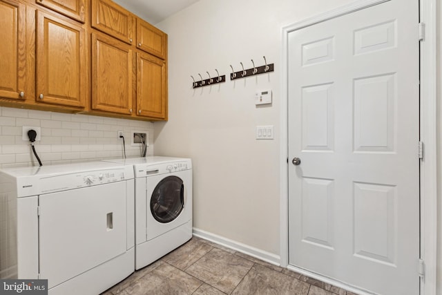 633 Ruxton Rd Unit 75, Solomons, MD 20688 - laundry area featuring cabinet space, independent washer and dryer, and baseboards