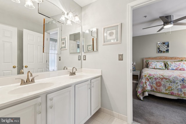 633 Ruxton Rd Unit 75, Solomons, MD 20688 - bathroom with double vanity, ensuite bathroom, a ceiling fan, baseboards, and tile patterned floors
