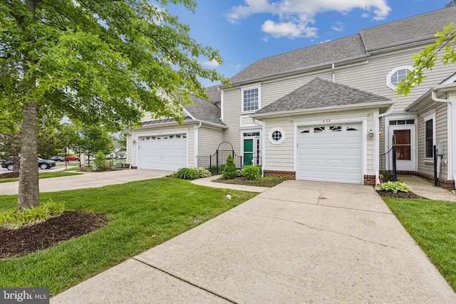 633 Ruxton Rd Unit 75, Solomons, MD 20688 - view of front of property with concrete driveway, an attached garage, a shingled roof, and a front lawn
