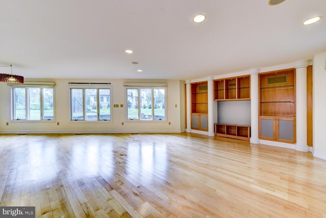 22 Slayback Dr, Princeton Junction, NJ 08550 - unfurnished living room with healthy amount of natural light, light wood finished floors, recessed lighting, and ornate columns