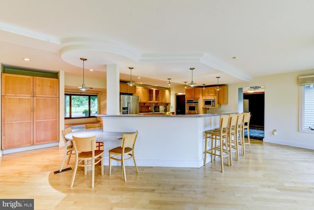 22 Slayback Dr, Princeton Junction, NJ 08550 - kitchen featuring appliances with stainless steel finishes, a kitchen bar, light wood-style flooring, glass insert cabinets, and recessed lighting