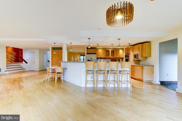 22 Slayback Dr, Princeton Junction, NJ 08550 - kitchen with stainless steel appliances, light wood-style floors, and a kitchen breakfast bar