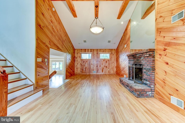 22 Slayback Dr, Princeton Junction, NJ 08550 - unfurnished living room with wood walls, wood finished floors, stairway, and a fireplace