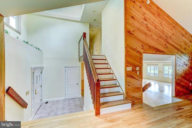 22 Slayback Dr, Princeton Junction, NJ 08550 - stairway featuring a towering ceiling, wood walls, wood finished floors, and french doors