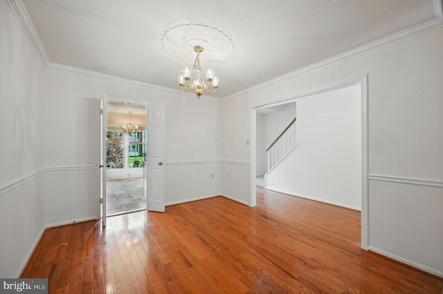 11707 Critton Cir, Woodbridge, VA 22192 - unfurnished room with a chandelier, wood finished floors, ornamental molding, and stairs