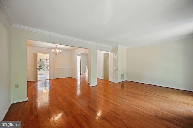 11707 Critton Cir, Woodbridge, VA 22192 - spare room with a chandelier, hardwood / wood-style floors, ornamental molding, and stairway
