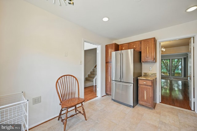 11707 Critton Cir, Woodbridge, VA 22192 - kitchen featuring freestanding refrigerator, brown cabinets, recessed lighting, and light stone counters