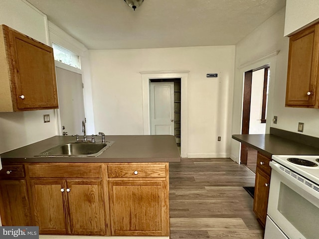 115 Bellevue St, Cumberland, MD 21502 - kitchen with electric stove, a sink, dark countertops, and wood finished floors
