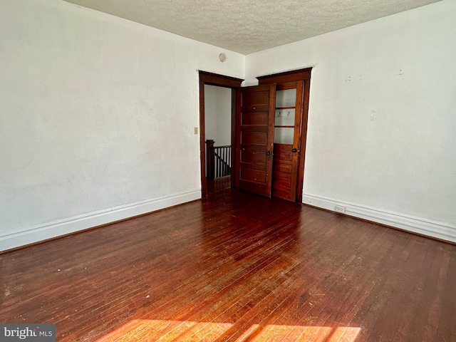 115 Bellevue St, Cumberland, MD 21502 - unfurnished room featuring baseboards, hardwood / wood-style floors, and a textured ceiling
