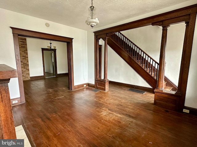 115 Bellevue St, Cumberland, MD 21502 - unfurnished dining area with hardwood / wood-style floors, baseboards, and a textured ceiling
