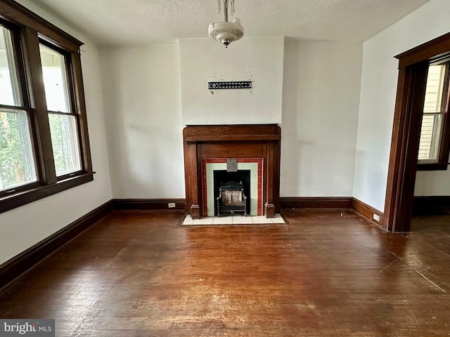 115 Bellevue St, Cumberland, MD 21502 - unfurnished living room with a textured ceiling, wood finished floors, and baseboards