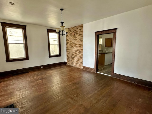 115 Bellevue St, Cumberland, MD 21502 - empty room featuring dark wood-style flooring, baseboards, a sink, and a chandelier