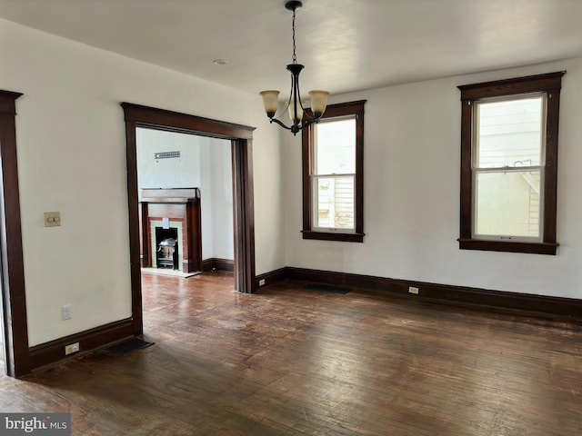 115 Bellevue St, Cumberland, MD 21502 - unfurnished dining area featuring dark wood-style flooring, a chandelier, and baseboards