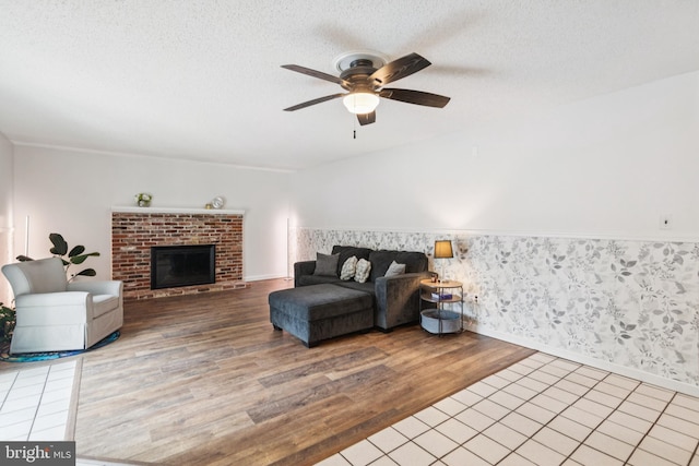 20 Hydra Ln, Sewell, NJ 08080 - living area featuring wood finished floors, a ceiling fan, a textured ceiling, a brick fireplace, and baseboards